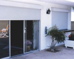 White roll up & down shutters over sliding glass doors installed by Inter Trade Incorporated